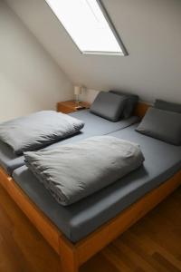 a bed with two pillows on it in a room at Stairway to Ljubljana Apartment in Ljubljana