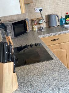 a kitchen with a counter top with a stove at Belle Vue in Pontnewynydd