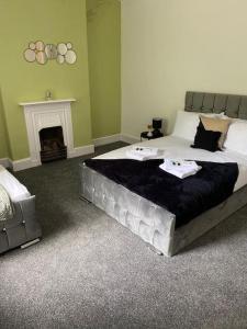 a bedroom with a large bed and a fireplace at Belle Vue in Pontnewynydd