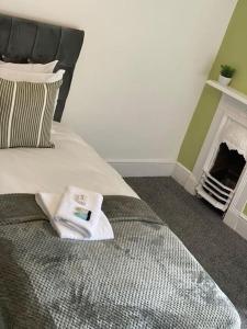 a bedroom with a bed with a towel on it at Belle Vue in Pontnewynydd