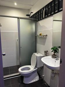 a bathroom with a toilet and a sink at Cozy Homestay Cyber City 3BR Near KKIA 10 minutes KK Centre wifi 30mps astro channel in Kapayan