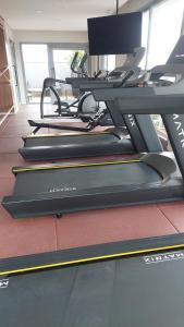 a row of treadles on a treadmill in a gym at Studio Vila Mariana in Sao Paulo