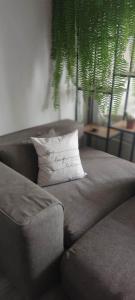 a couch with a pillow with the words never quit at Студио Bella in Varna City