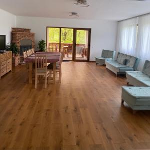 a living room with a table and chairs and a couch at Relikvia in Sovata