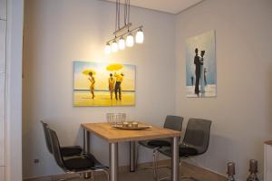 a dining room with a table and chairs with umbrellas at Seebach Wohnung 06 in Boltenhagen