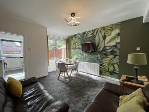 a living room with a couch and a table at Modernised central Wigan townhouse sleeps up to 6 in Wigan
