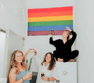 a group of three women sitting on top of a refrigerator at Doña Rose Coliving in Las Palmas de Gran Canaria