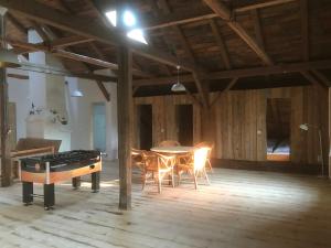 a dining room with a table and chairs and a stove at Haidhäusl in Haidmühle