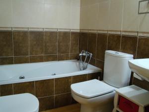 a bathroom with a toilet and a tub and a sink at Maestro Bayarri HC-2D in Peniscola +18 photos