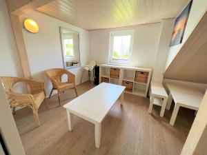 a living room with a white table and chairs at Strandpark Sierksdorf H091 in Sierksdorf