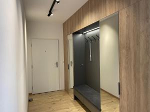 a hallway with a large glass door with a bench at AH Galvaniho in Bratislava