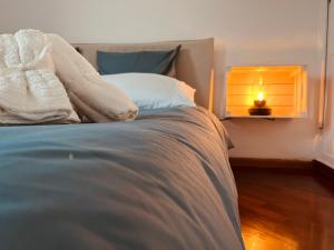 a bedroom with a bed with a light on it at La Finestra Sul Mare - [Sea View] in Genova