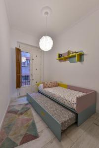1 dormitorio con cama y lámpara de araña en Casa Carmen Murcia, en Murcia