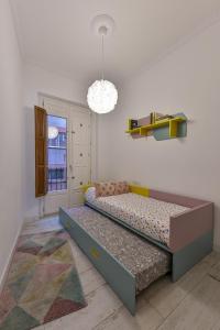 a bedroom with a bed and a chandelier at Casa Carmen Murcia in Murcia