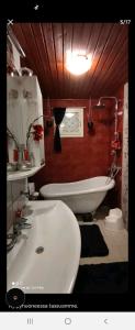 a bathroom with a white sink and a tub at Kaunis omakotitalo Sahalahdessa 