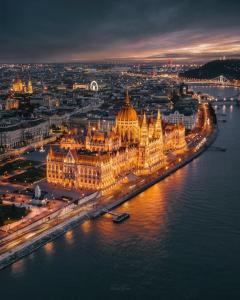 a view of the hungarian parliament building at night at Balázs Guesthouse in Budapest