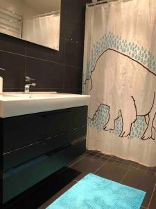La salle de bains est pourvue d'un rideau de douche avec un chien. dans l'établissement Stor lägenhet - 150 meter från havet., à Helsingborg