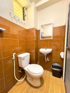 a bathroom with a toilet and a sink at Andrew & Mary's Lodging House in Sagada