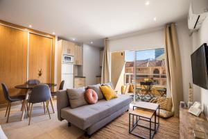 salon z kanapą i stołem w obiekcie Sur Suites PYR vista mar w mieście Fuengirola