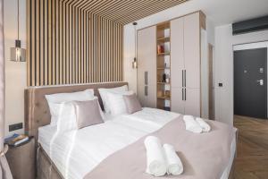 una camera da letto con un grande letto bianco con asciugamani sopra di Villa Golden Shine a Funtana
