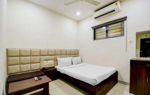 a bedroom with a bed and a window and a air conditioner at Kyd Guest House Near Indian Museum in Kolkata