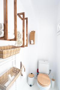 a bathroom with a toilet and a basket of towels at Kellys house in Epanomi