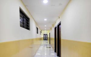 a hallway with white walls and a long hallway at Kyd Guest House Near Indian Museum in Kolkata