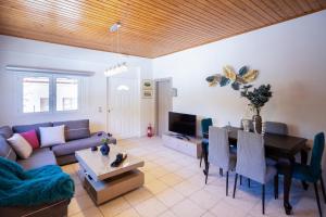 a living room with a couch and a table at Zante Sunny Mountain in Anafonítria