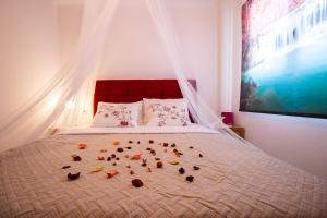 a bedroom with a bed with a bunch of shoes on it at Zante Sunny Mountain in Anafonítria