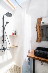 a bathroom with a shower and a wooden table at Kellys house in Epanomi