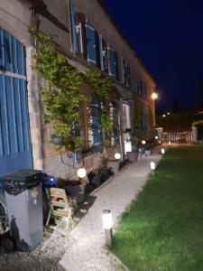 a building with lights on the side of it at night at La Charentaise des Lilas in Saint-Léger