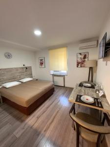 a hotel room with a bed and a table at Smart Apart in Vinnytsya