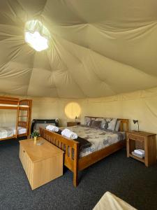 a bedroom with two beds in a tent at Dukeries Retreat in Retford