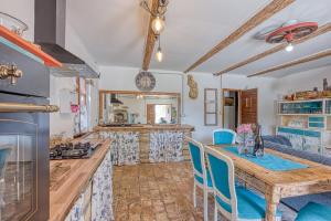 a kitchen with a wooden table and blue chairs at Rustic Home Izabel - Happy Rentals in Pazin