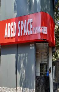a sign for a red space parking outpost at Ared Space-Near Vile Parle Railway Station in Mumbai
