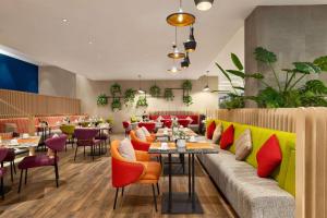 a restaurant with colorful furniture and tables and chairs at La Quinta by Wyndham Dubai Jumeirah in Dubai