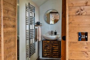 a bathroom with a sink and a mirror at Finest Retreats - Trevoya Cabin in Launceston