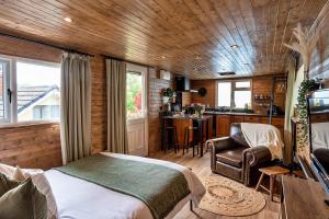 a bedroom with a bed and a kitchen in a house at Finest Retreats - Trevoya Cabin in Launceston