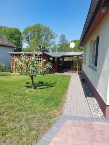 a house with a walkway next to a yard at Ferienhaus Flessenow am Schweriner See in Flessenow