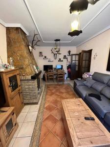 a living room with a blue couch and a table at Chalet , a 6km de la playa in Chiclana de la Frontera