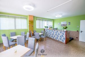 a waiting room with tables and chairs and a counter at EURHOTEL in Florence