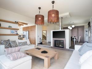 a living room with white furniture and a fireplace at Villa Amavi - Private heated pool in Kato Asites