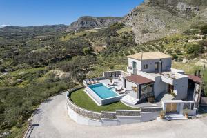 an aerial view of a house with a swimming pool at Villa Amavi - Private heated pool in Kato Asites