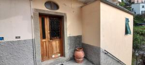 a door of a house with a vase next to it at Hotel Villa Argentina in Riomaggiore