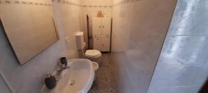 a bathroom with a sink and a toilet and a mirror at Hotel Villa Argentina in Riomaggiore