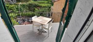 a small table and chairs on a balcony at Hotel Villa Argentina in Riomaggiore