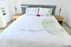 a bed with the words your happy place on it at Casa Cohen C Kineret קאסה כהן סי כנרת in Migdal