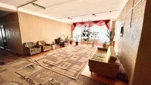 a living room with a couch and a rug at Sanatoriy Samara 