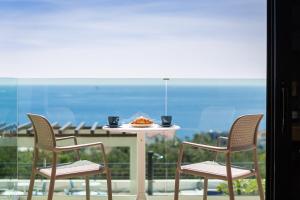 un tavolo con un piatto di cibo e due sedie di Sun Resort Apartments a Zečevo