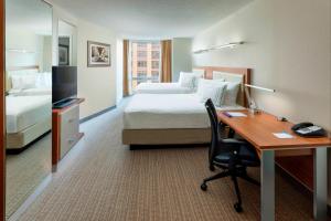 a hotel room with a desk and a bed at SpringHill Suites Chicago Downtown/River North in Chicago